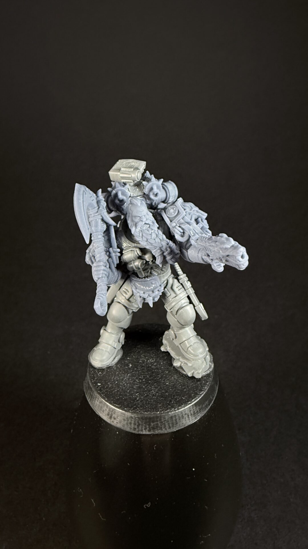 Gray plastic tabletop miniature of an armored warrior with a dragon-head mount, standing on a round base with a shield and weaponry visible.